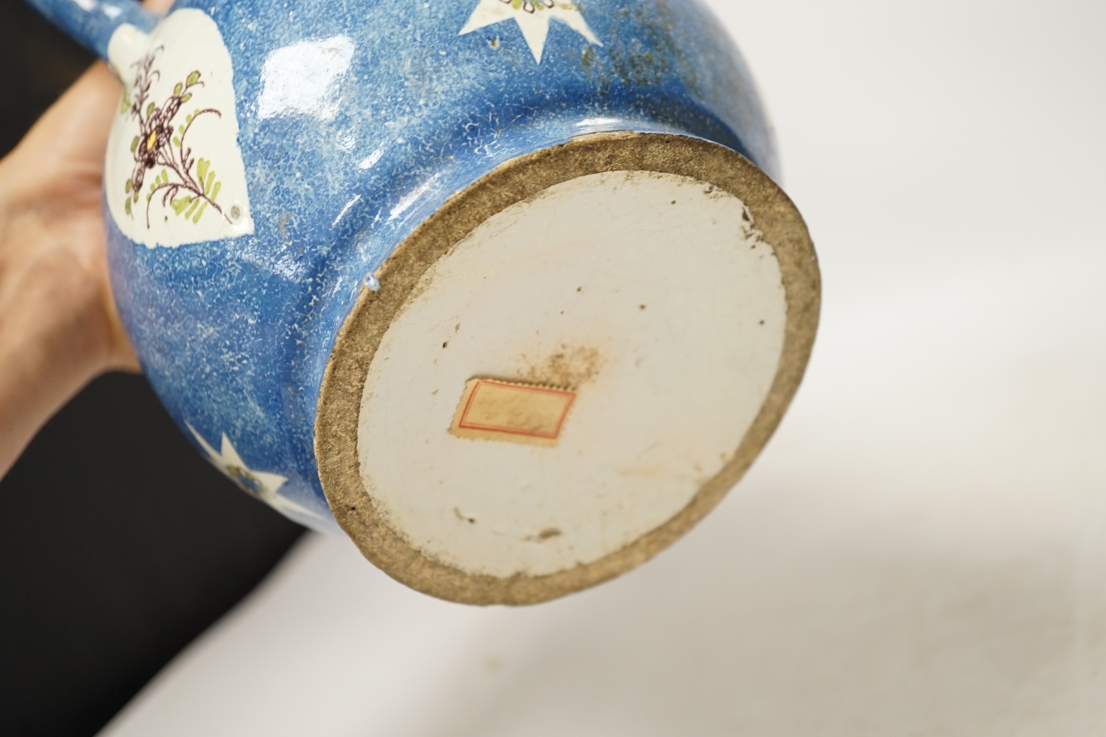 An 18th / 19th century Brussels faience jug and a French Quimper faience pottery jug, largest 25cm high. Condition - fair to good
